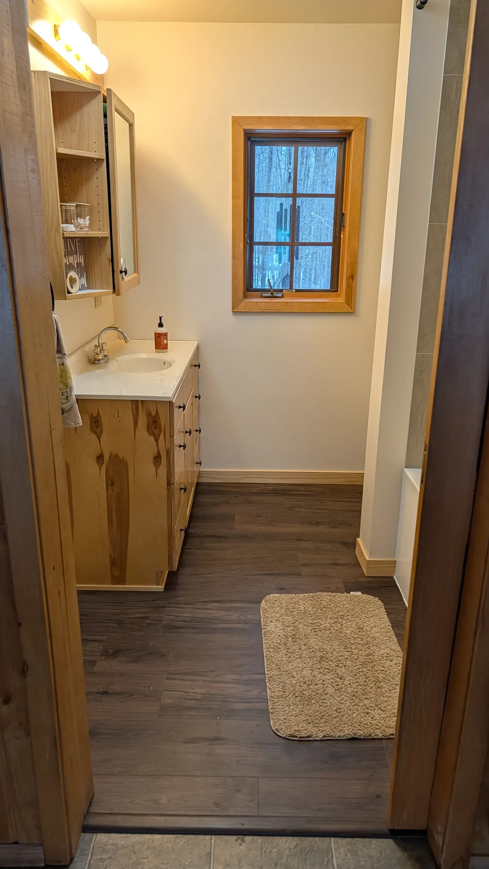 Renovated bathroom with pine vanity, granite top, and new LVP flooring