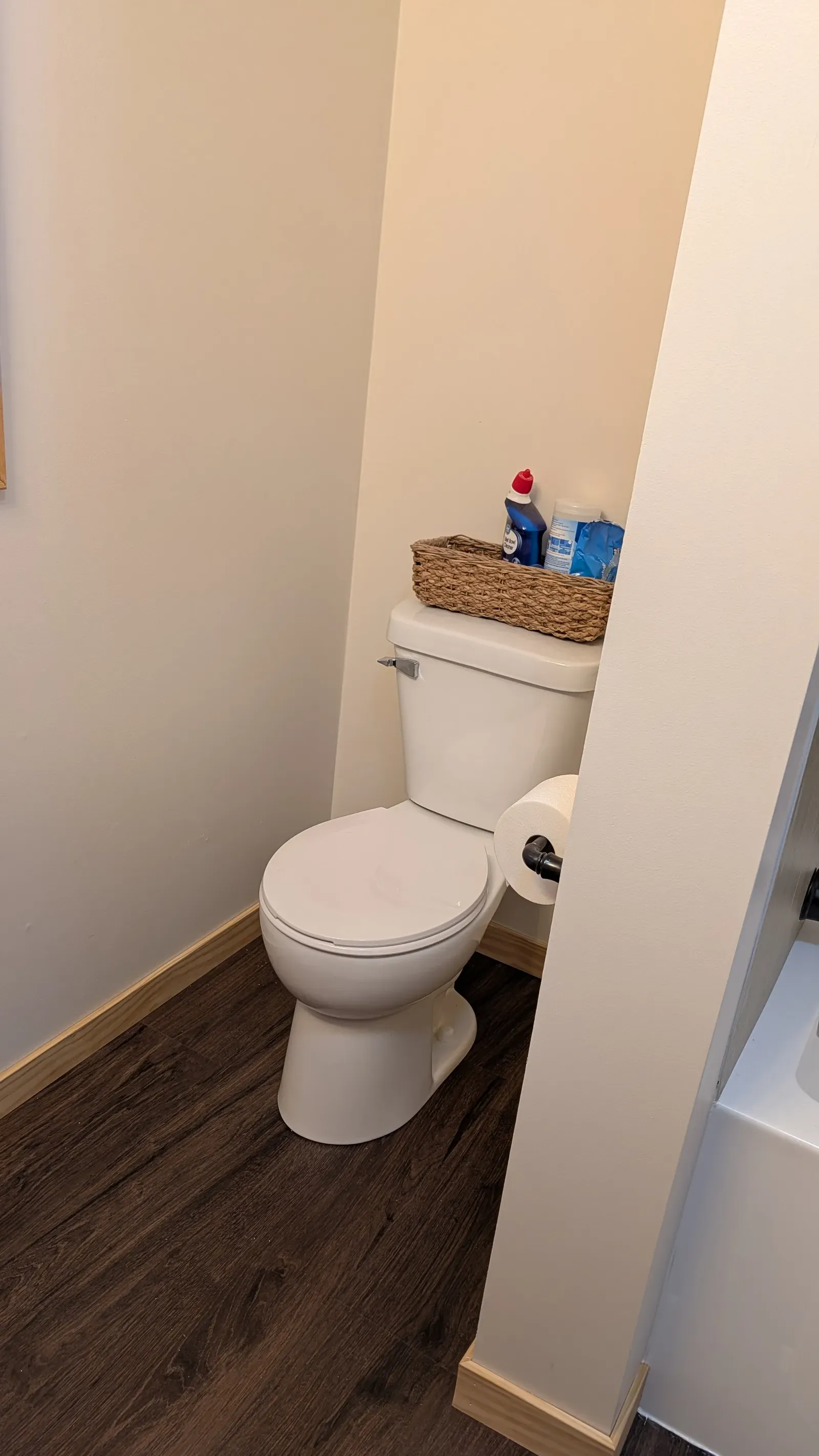 New toilet alcove with clean drywall and waterproof LVP flooring