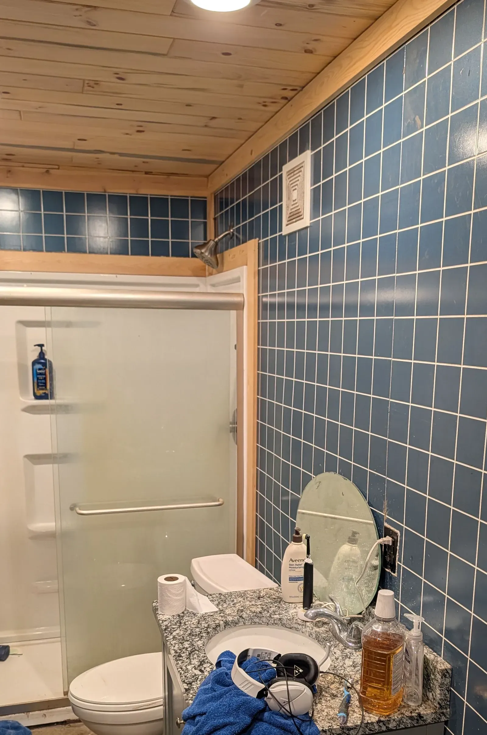 Renovated bathroom with new vanity, storage cabinet, tub/shower combo, and LVP flooring