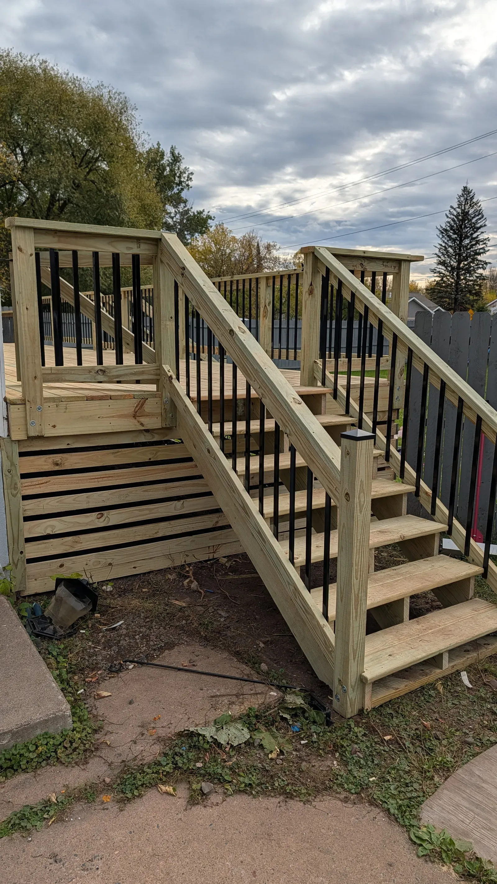 New pressure-treated deck with stairs, aluminum balusters, and code-compliant railing in Hermantown