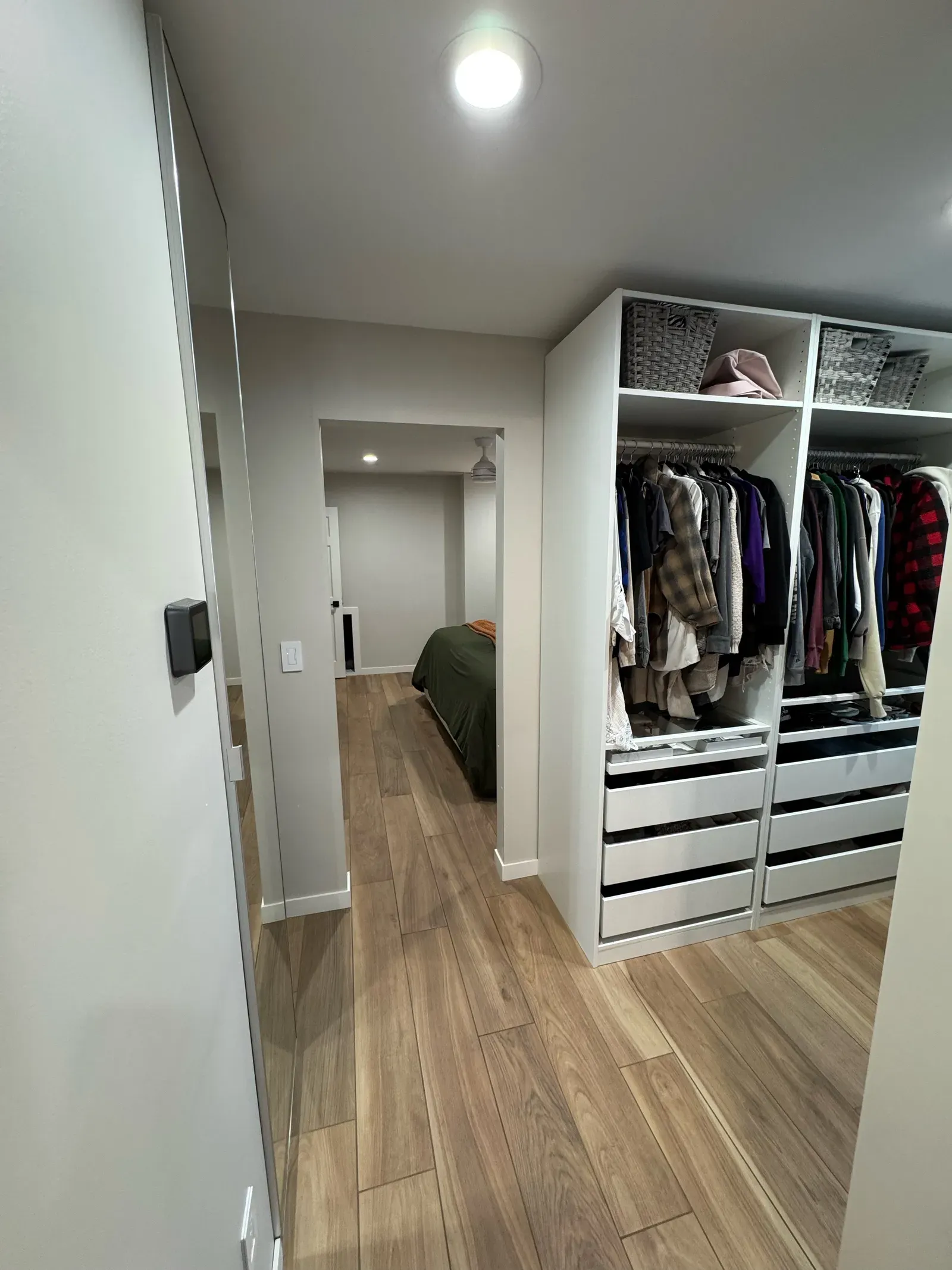Organized master closet with custom shelving