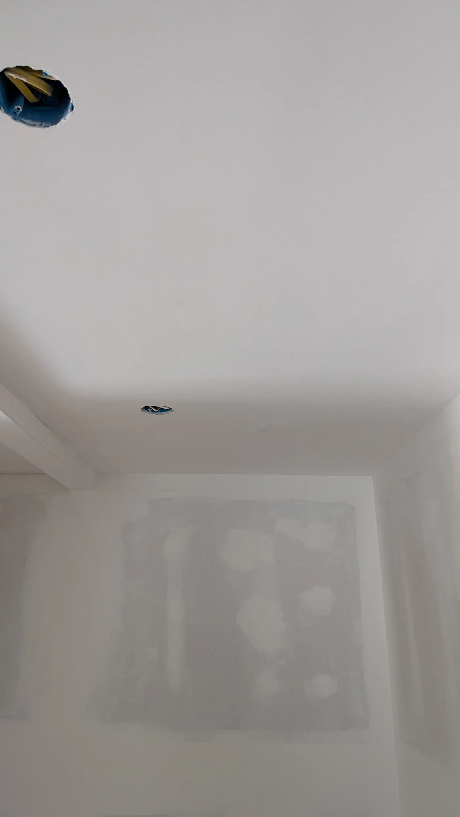 Unfinished drywall showing taped seams, mud, and open ceiling fixture boxes in Carlton County home